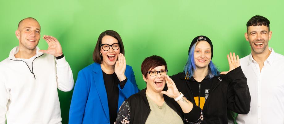 5 lächelnde Menschen vor grünem Hintergrund